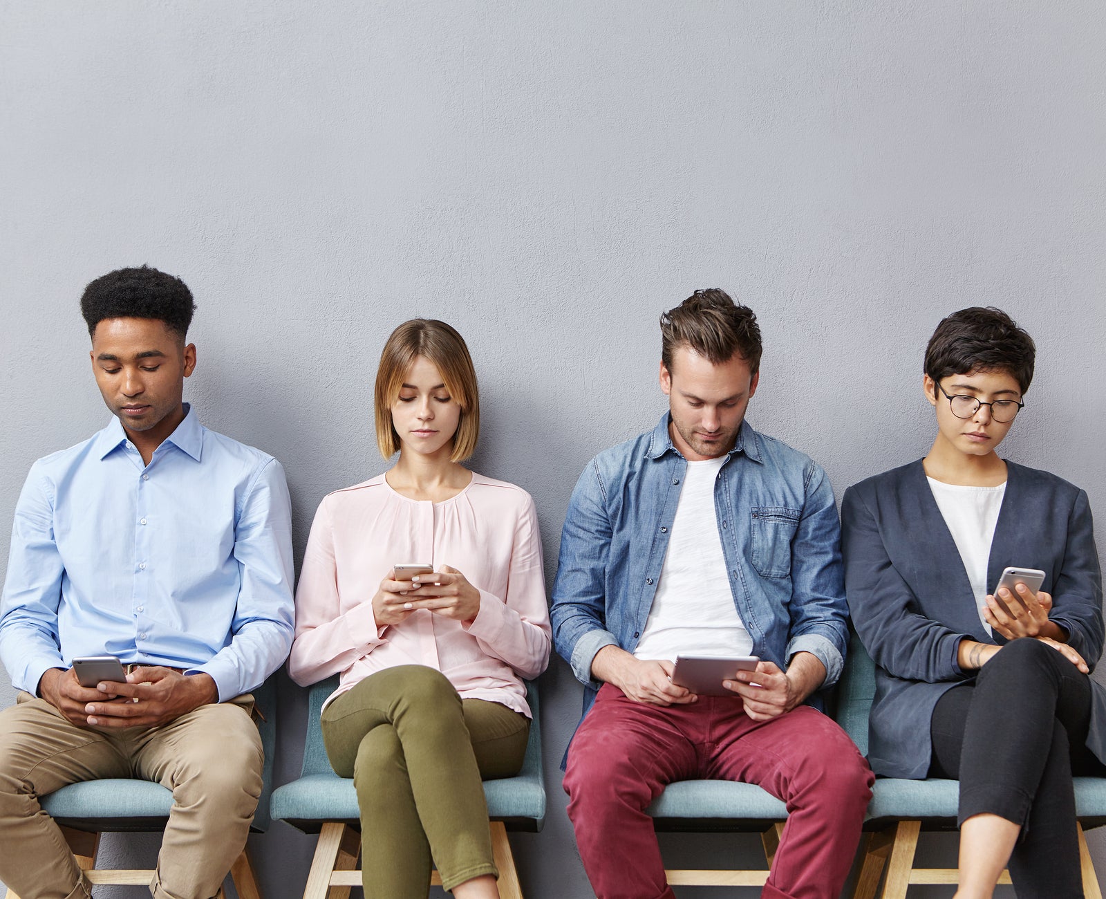 Diverse Group of Students Sitting Reading Devices