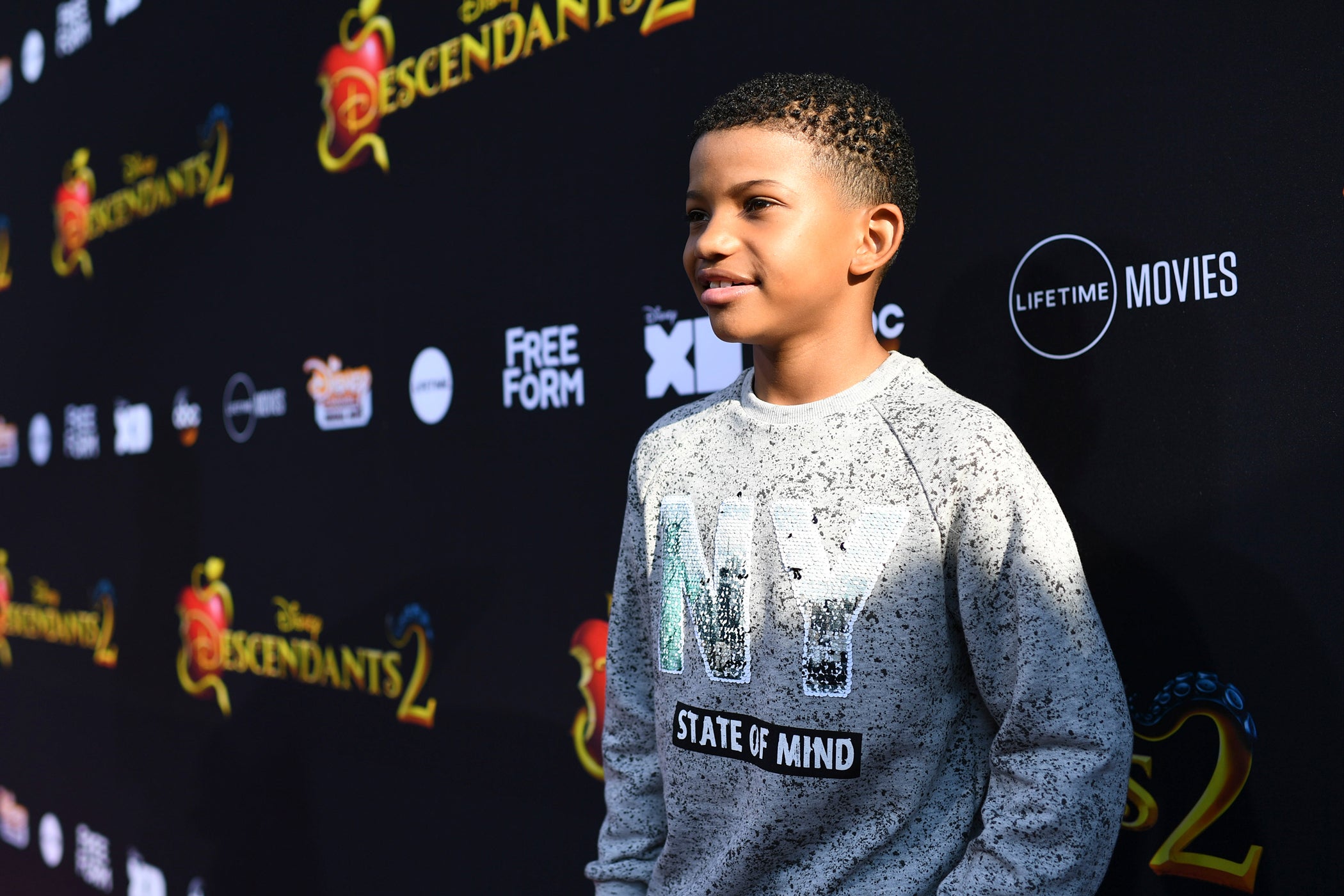 Actor Lonnie Chavis Poses in front of Walt Disney Wall