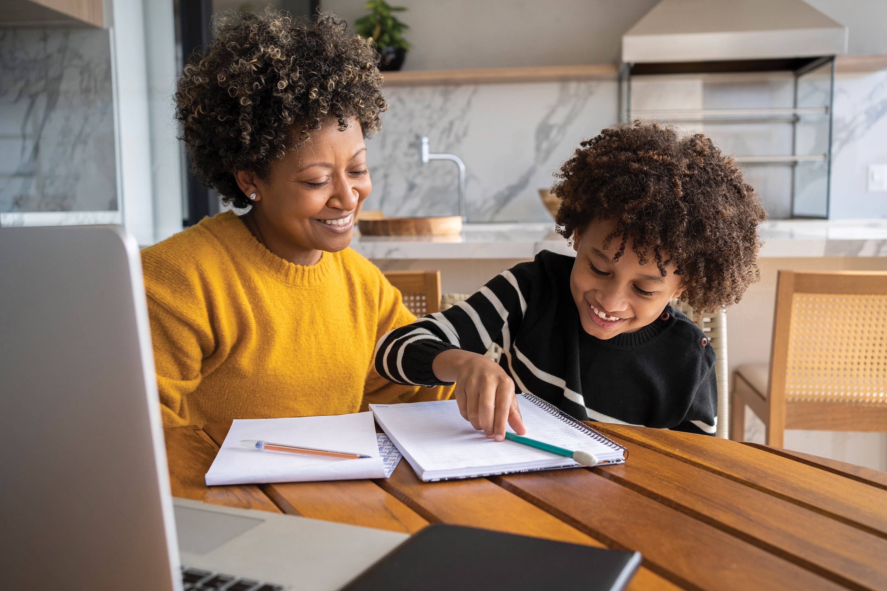 African American mom helping son to study online