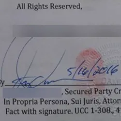 An image showing a signature with a red finger print