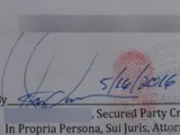 An image showing a signature with a red finger print